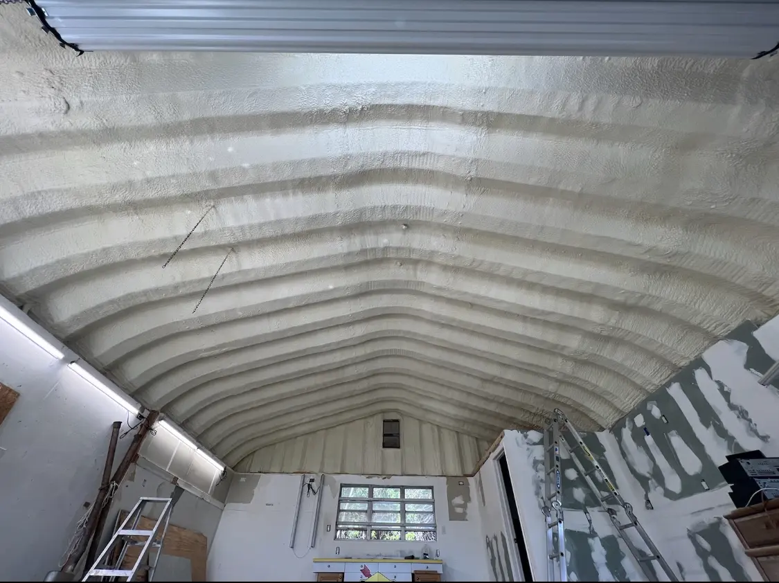 Spray polyurethane foam applied to the underside of a metal roof deck in East Bethel